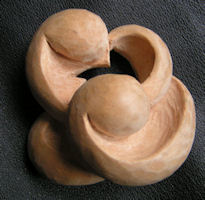 Hand-held meditation woodcarving titled The Hole Where Thoughts Go